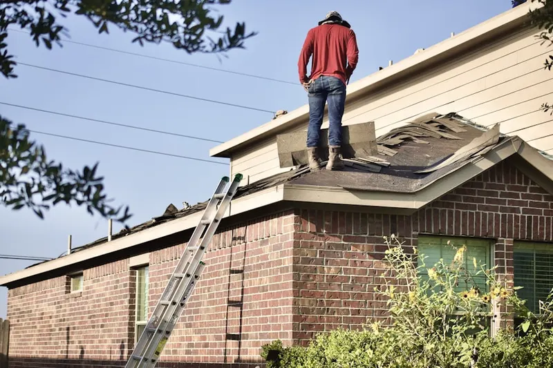 Professional roofer working on a residential roof in Webster Groves